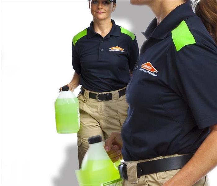 SERVPRO technicians holding our green general cleaning products